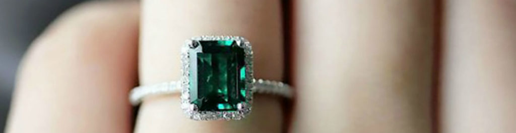 emerald engagement ring on womans hand desktop 1